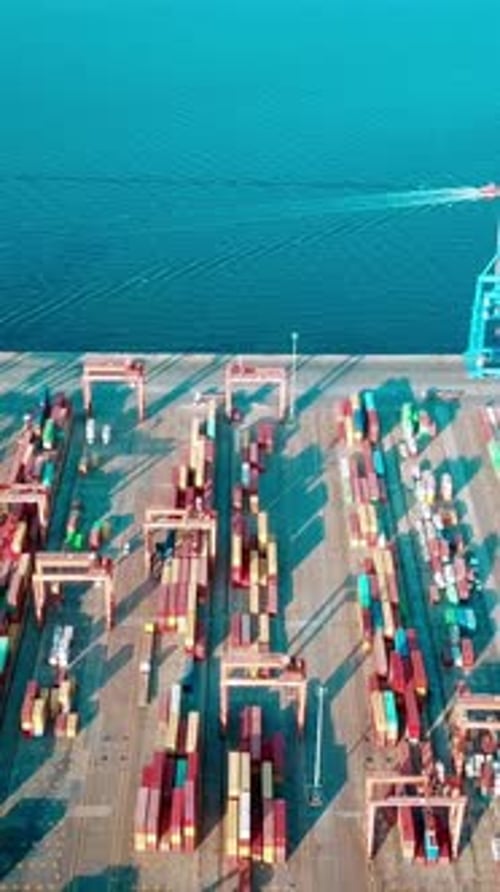 Vidéo verticale du port - Images filmées par drone de conteneurs, de cargos et de grues de chargement dans le port
