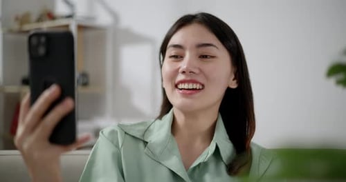Young Woman Chatting on Smartphone Video Call