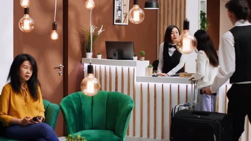 Young Traveler Arriving at Hotel Lobby with Luggage