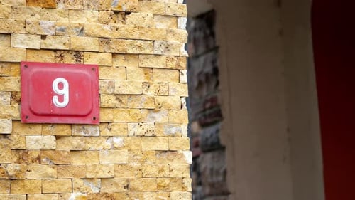 Textured Brick Wall with Number Nine Sign