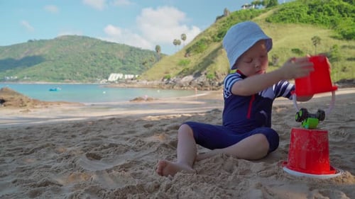 Cute Boy Plays on Sandy Tropical Beach