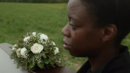 Woman Mourning at a Funeral Ceremony Outdoors