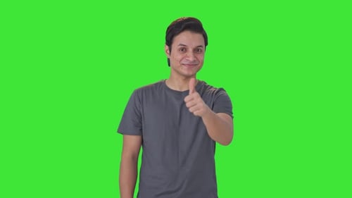 Happy Indian man showing thumbs up Green screen