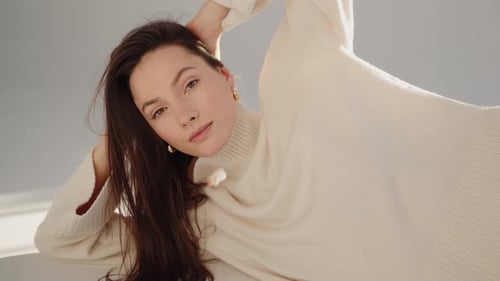 Brunette Model Posing in Cream Sweater