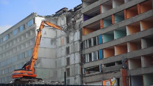 Excavator Demolishing Building for Construction