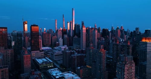 Twilight in the stunning New York, United States. The tops of the skyscrapers are lit with last rays
