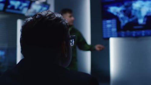 Men attending meeting in monitoring control room