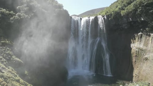 Beautiful Waterfall Flowing Down Mossy Cliffside