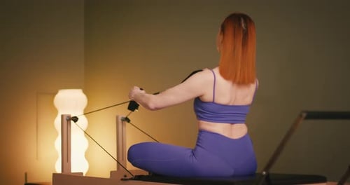 Woman Working Out on Pilates Machine