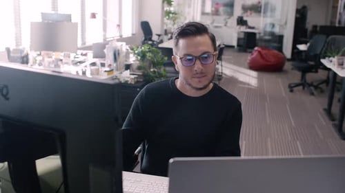 Focused Creative Businessman Working at Laptop and Computer in Office 3034 Years