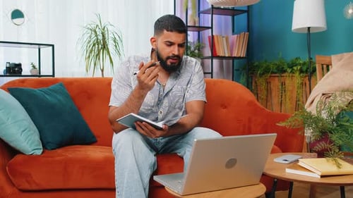 Man Working from Home on Couch with Laptop