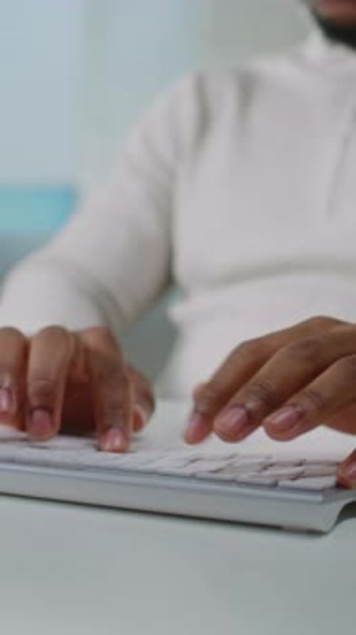 Close Up of African American Ecommerce Manager Typing on Keyboard Chatting with Client Using PC