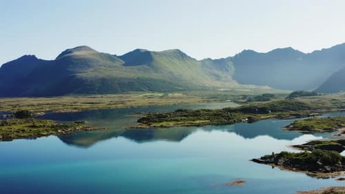 Lake Mirroring The Graceful Form Of The Mountain Range