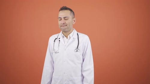 Frustrated Doctor Expressing Stress on Orange Background