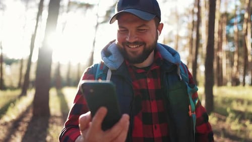 Active Man Hiking in Forest Alone Tourist with Carrying Backpack Hiking Finding Route Way Looking at