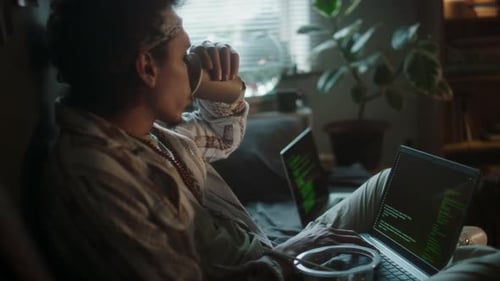 Young Adult Working on a Laptop at Home