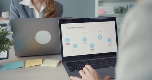 Asia businesswomen using laptop on table working and communicate sitting on office desk.