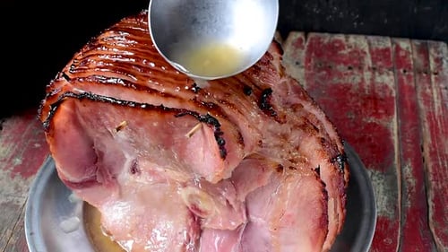 ladle juice over baked spiral cut ham