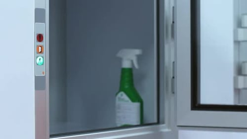 Medical Professional Removing Disinfectant from Sterile Compartment