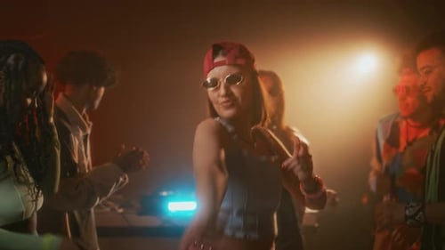 Lady in Stylish Retro Outfit Rocking out to Music with Friends in Club