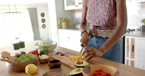 Woman Smiling While Preparing Salad in Kitchen
