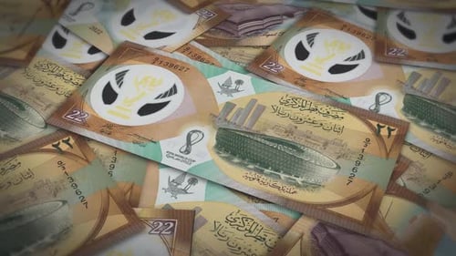 Pile of qatar riyal cash money, inflation concept. Closeup new qatar twenty two riyal bills