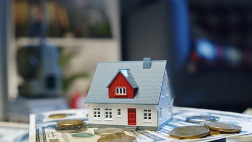 House Expense Planning Small Home On Stack Of Dollars Scene