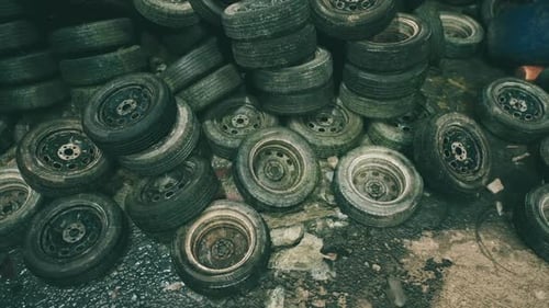 Piles of Discarded Tires in a Neglected Urban Area During Daylight