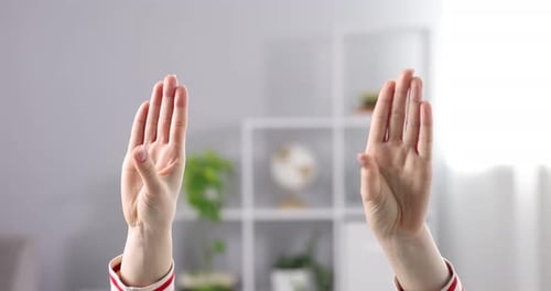 Woman showing signal for help at home, closeup