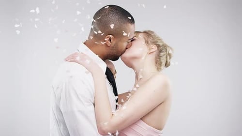 4k video footage of a young couple kissing against a studio background