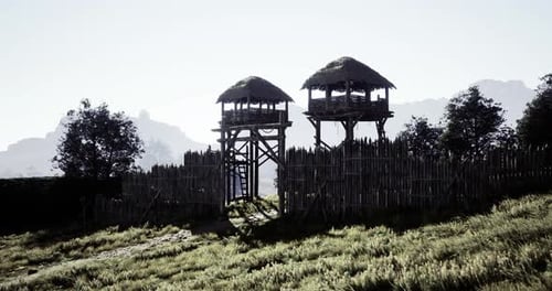 Historic Watchtowers Overlooking a Lush Green Landscape at Sunrise