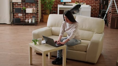 Woman Working from Home on Laptop