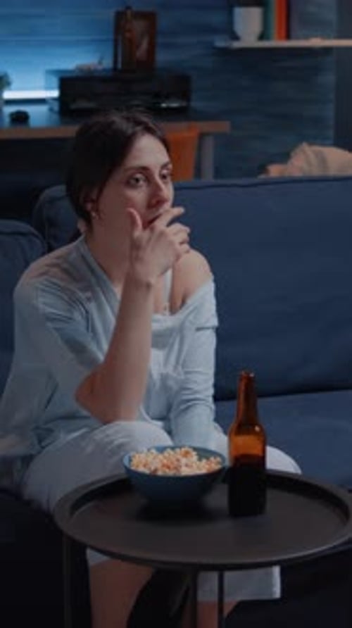 Vertical Video Astonished Woman Looking at Movie at Tv Having Surprised Facial Expression
