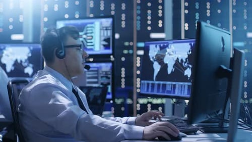 Professional Technical Support Personnel Working in a System Control Center. We See Many Working Di