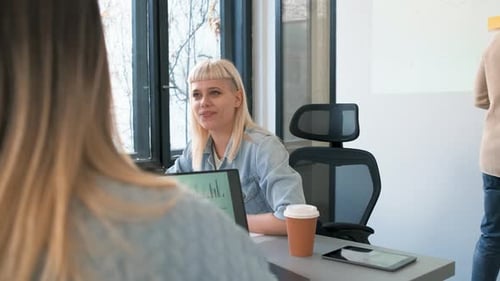 Diverse group of young people working on new project together in office.