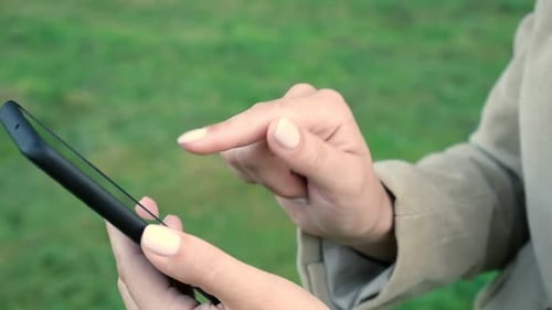 Close Up of Adult Using Smartphone Outside