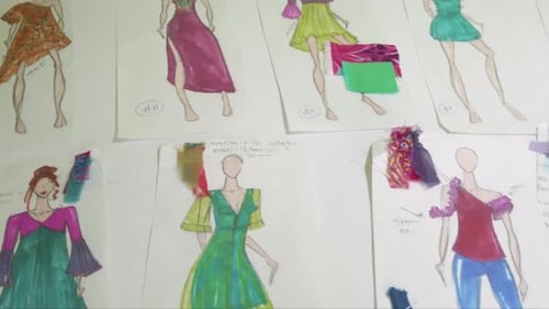 Fashion Design Sketches on Table with Colorful Designs
