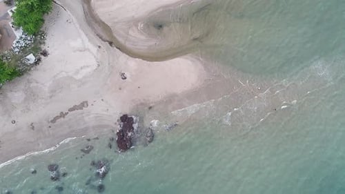 Aerial drone footage of sea ocean waves reaching shore. Beach with aerial drone. Beach clear turquoi