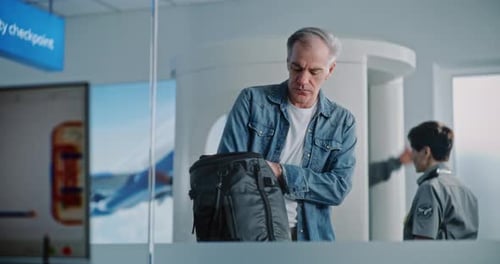 Man Opens Backpack at Airport Security Checkpoint