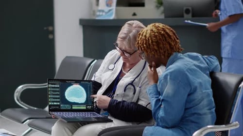 Doctor Reviews Brain Scan with Patient in Hospital