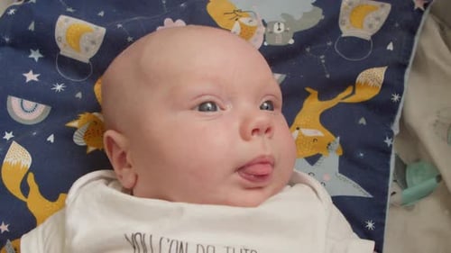 Cute Infant Lying on Blanket Smiling