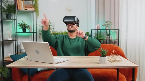 Man Wearing VR Headset Gesturing at Home
