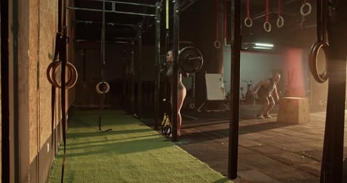 Woman and Man Training in Gym