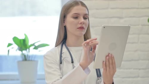 Female Doctor using Digital Tablet in Clinic