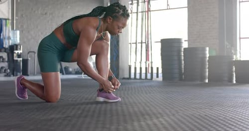 Stretching in gym, woman in athletic wear preparing for workout session, copy space