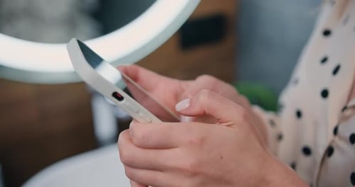 Closeup of female hands holding a phone typing a message communication and chatting on social online
