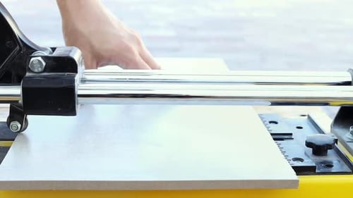 Tile Cutter Scoring a Tile for Renovation
