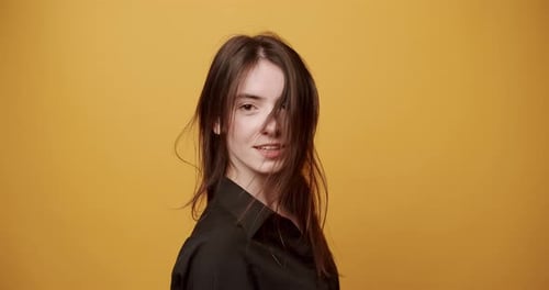 Smiling Woman with Long Hair Tossing Hair