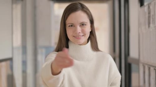 Portrait of Confident Young Woman Inviting People