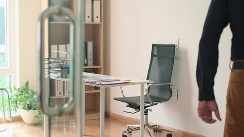 Manager Coming to His Workplace in Office